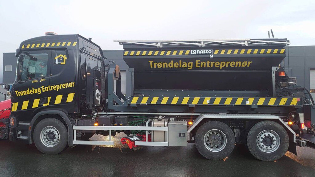 Svart lastebil med logo for Trøndelag Entreprenør.